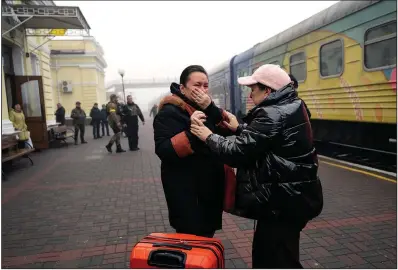  ?? (The New York Times/Lynsey Addario) ?? Two women weep Monday as they are reunited at the train stattion in Kherson, Ukraine. Train service to Kherson has resumed, a step in reconnecti­ng the city to the rest of Ukraine a week after Ukrainian troops took back control of it from Russian occupation.