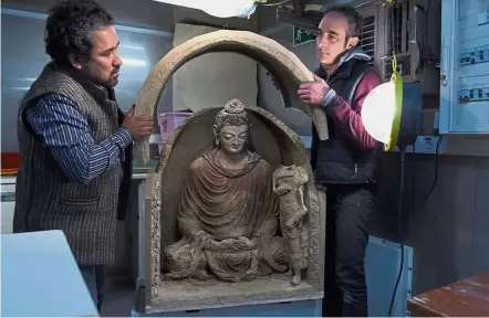  ??  ?? Well preserved: Carbonara (right) and head of the French Archaeolog­ical Delegation to Afghanista­n Julio BendezuSar­miento unveiling the Buddha statue at the DAFA office in Kabul. – AFP