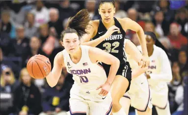  ?? Stephen Dunn / Associated Press ?? UConn’s Molly Bent heads down court followed by Central Florida’s Brittney Smith (32) during the first half on Saturday in Storrs.