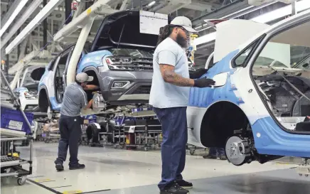  ??  ?? Volkswagen employees work at the plant in Chattanoog­a. State economists estimate VW’s initial $1 billion investment in the plant spurred 12,400 jobs, and last year’s $900 million expansion should add an additional 9,799 posts in Tennessee. ERIN O....