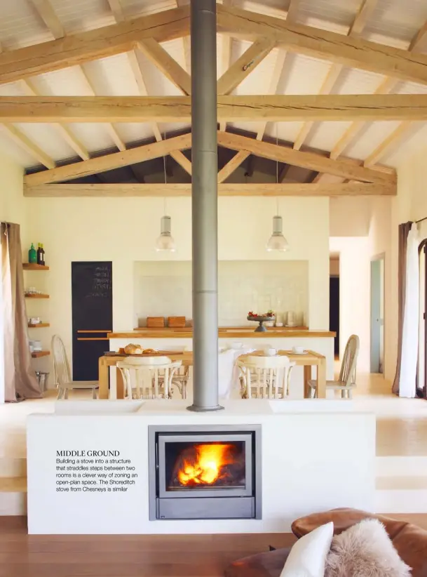  ??  ?? MIDDLE GROUND Building a stove into a structure that straddles steps between two rooms is a clever way of zoning an open-plan space. The Shoreditch stove from Chesneys is similar