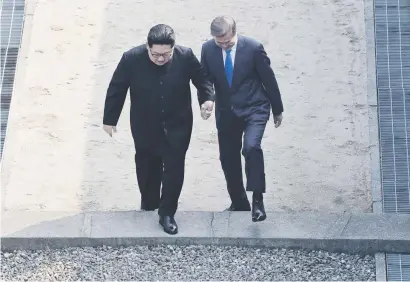  ?? Picture: Reuters ?? HAND IN HAND. South Korean President Moon Jae-in and North Korean leader Kim Jong-un meet in the truce village of Panmunjom inside the demilitari­sed zone separating the two Koreas.