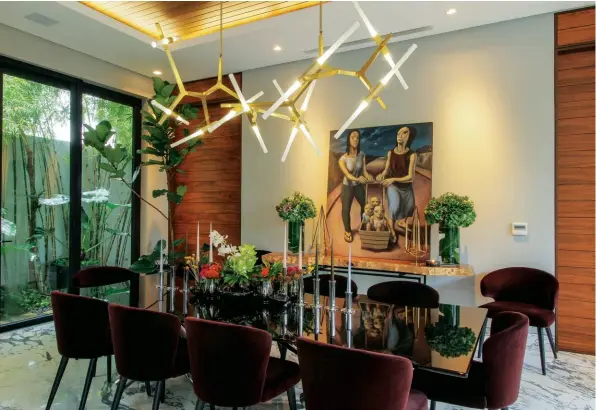  ??  ?? MIRROR, MIRROR In the dining room, a striking Poliform chandelier above the Minotti dining table vies with Borlongan’s Stroller for attention; Soft lighting and geometric patterns rule the guest bathroom