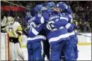 ?? CHRIS O’MEARA — THE ASSOCIATED PRESS ?? Tampa Bay’s Steven Stamkos (91) is swarmed by teammates after scoring against the Penguins Thursday in Tampa, Fla.