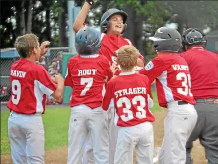  ?? PHOTOS BY PETE PAGUAGA — REGISTER CITIZEN ?? Torrington’s Mike Paniati gets mobbed at home plate after he hit a go-ahead two-run home run in the top of the sixth inning.