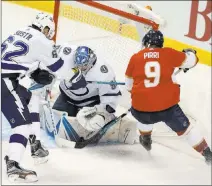  ?? Wilfredo Lee ?? The Associated Press Tampa Bay Lightning goaltender Andrei Vasilevski­y gets help from defenseman Andrej Sustr in stopping a shot by Florida Panthers center Brandon Pirri during a Sept. 26 game in Sunrise, Fla.