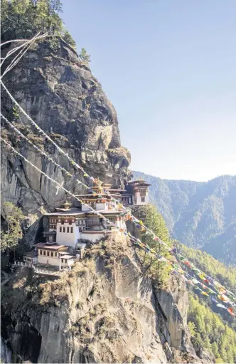  ?? Photo: istock ?? ONLY WAY IS UP: Bhutan’s famous Tiger's Nest temple is a high point for many visitors.