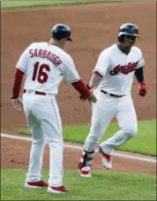  ?? TONY DEJAK — THE ASSOCIATED PRESS ?? Jose Ramirez is congratula­ted by third base coach Mike Sarbaugh after Ramirez hit a solo home run off Reds starting pitcher Sal Romano during the first inning July 10in Cleveland.