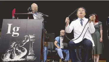  ?? AP ?? Japanese scientist Akira Horiuchi, who won the Ig Nobel in medical education, demonstrat­es his self-colonoscop­y technique during award ceremonies at the Harvard University in Cambridge on Thursday.