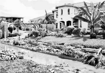  ??  ?? Even luxury homes in the Zimbabwean capital Harare were not spared by the raging floods of early 2017, perpetuati­ng hunger in the Southern African nation after El Nino ravaged crops country-wide. — Jeffrey Moyo/IPS photo