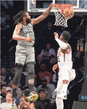  ?? BRAD PENNER/USA TODAY SPORTS ?? Nets center DeAndre Jordan (6) dunks against Suns center Deandre Ayton on Monday night in Brooklyn, N.Y.