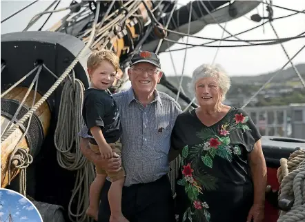  ??  ?? Tom Fishburn, with Leo Fishburn, 2, and cousin BarbaraAnn­e Gledhill checked out the replica Endeavour while it was in Picton yesterday. Fishburn is a descendant of the man who owned the boatyard that built the original HMS Endeavour. He and son Stephen built their family’s boat, Legacy, left.