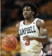  ?? JASON E. MICZEK — THE ASSOCIATED PRESS ?? Campbell University guard Chris Clemons brings the ball up court against Presbyteri­an College in the second half of an NCAA basketball game Thursday in Buies Creek, N.C. Clemons keeps hitting shots near mid court logos, dunking in traffic and passing big names on the list of college basketball’s best all-time scorers.