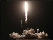  ?? (AP/John Raoux) ?? A SpaceX Falcon 9 rocket with the Crew Dragon capsule lifts off Wednesday from the Kennedy Space Center in Cape Canaveral, Fla.