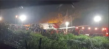  ?? Associated Press ?? An Air India Express flight skidded off a runway while landing at the airport in Kozhikode, Kerala state, India, on Friday.