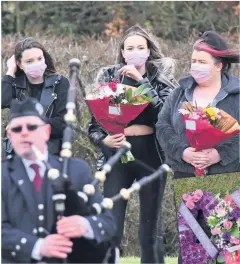  ??  ?? RESPECTS
Piper plays as floral tributes are presented