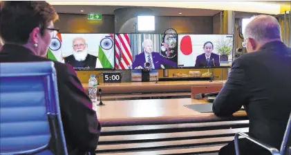  ?? Dean Lewins The Associated Press ?? Australia’s Prime Minister Scott Morrison and Minister for Foreign Affairs Marise Payne attend a virtual meeting with fellow leaders of the Quad: India Prime Minister Narendra Modi, President Joe Biden and Japan Prime Minister Yoshihide Suga.