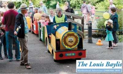  ??  ?? Members of the Lions Club of Maidenhead holding its annual fun day, including a duck derby, on Ray Mill Island. Ref: 128135-1