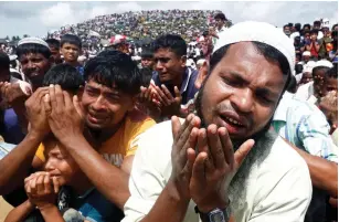 ?? (Rafiqur Rahman/Reuters) ?? ROHINGYA REFUGEES take part in a prayer as they gather to mark the second anniversar­y of their exodus at the Kutupalong refugee camp in Cox’s Bazar, Bangladesh.