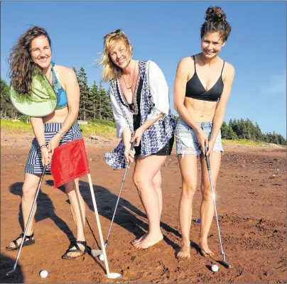  ?? EVAN CERETTI/THE GUARDIAN ?? Golfers, from left, Ellen Trainor, Amber Ceretti and Lysine Soucy take a whack at playing golf on the sand during the Caseys’ 30th annual Sand Bar Golf Tournament in Seven Mile Bay.