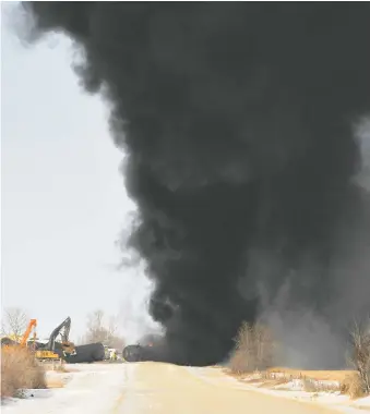  ??  ?? Smoke billows from the wreckage of a derailed Canadian Pacific Railway train hauling crude oil near Guernsey last Dec. 9. A similar derailment occurred a few kilometres up the line two months later. REUTERS/FILES