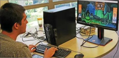  ?? SUBMITTED PHOTO ?? Devon Prep Senior Robert Young of Secane plays a video game on the computer he built during the school’s recent Tech Build Camp. This summer more than a dozen Devon Prep middle school and high school students attended week long camps where they learned...