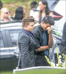  ?? Antonella Crescimben­i/Post-Gazette ?? Above: Mourners pay their respects as Antwon Rose II is laid to rest on Monday.