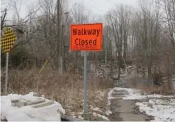  ?? JACK LAKEY/TORONTO STAR ?? A pedestrian path that runs across the top of a large culvert at the foot of Bennett Rd. has been closed since 2007, when the culvert was washed out by flooding.