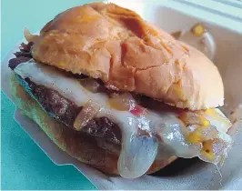  ??  ?? Meateor’s Cali burger is topped with Swiss cheese, bacon and grilled onions.