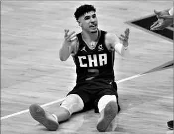  ?? AP Photo/Nell Redmond ?? Charlotte Hornets guard LaMelo Ball reacts during the second half of an NBA basketball game against the San Antonio Spurs in Charlotte, N.C., on Sunday, Feb. 14.