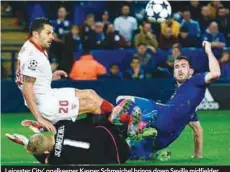  ??  ?? Leicester City’ goalkeeper Kasper Schmeichel brings down Sevilla midfielder Vitolo (left) in the area to concede a penalty during yesterday’s Champions League match at the King Power Stadium. – AFPPIX