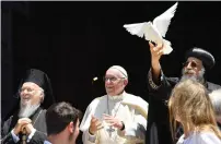  ?? AFP ?? Pope Francis and Ecumenic Patriarch of the Orthodox Church Bartolomeo I watch as Egypt’s Coptic Orthodox Pope Tawadros II releases a dove after a meeting in Bari. —