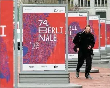  ?? /Reuters ?? Troubled film festival: A pedestrian walks past advertisin­g billboards for the upcoming 74th Berlinale Internatio­nal Film Festival in Berlin, Germany, in this photograph, which was taken on February 6.