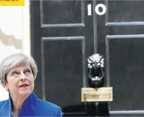  ?? JONATHAN BRADY/PA VIA AP) ?? Theresa May speaks to the media outside 10 Downing Street in London on Friday, The British prime minister’s gamble in calling an early election backfired spectacula­rly as her Conservati­ve Party lost its majority in Parliament, throwing British politics...