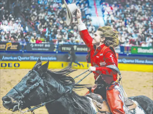  ?? Madeline Carter Las Vegas Review-journal ?? Rocker Steiner does a celebrator­y lap after winning in the first go-round of bareback riding on Friday during the National Finals Rodeo at the Thomas & Mack Center. His father, Sid, was the 2002 steer wrestling world champion.