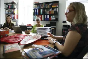  ?? MICHAL DYJUK — THE ASSOCIATED PRESS ?? Hannah Miller, left, Helise Lieberman, center, and Marta Saracyn speak during an interview with The Associated Press, July 28at the Lauder Morasha Jewish school in Warsaw, Poland.