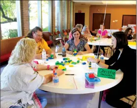  ?? Michael Shine/News-Times ?? Union Lego Training: Kindergart­en teachers in Union county went through LEGO Education training in September. LeeAnn Davis from Camden ABC, Stephanie Sliva from Harmony Grove ABC, Alicia Neely from Retta Brown ABC and Christie Galusha from Norphlet ABC used a kit of larger Legos to craft sculptures based on prompts such as to make something that can fly or a form of transporta­tion.