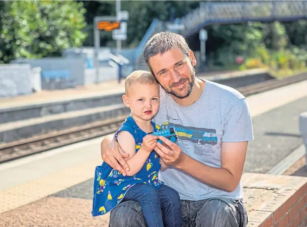  ??  ?? ACTION STATIONS: Pete Scott and daughter Elizabeth with her Thomas the Tank Engine toy at Invergowri­e station. Picture by Steve MacDougall.