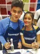  ??  ?? Bailey May and Ylona Garcia lend hands at the MYOH booth.