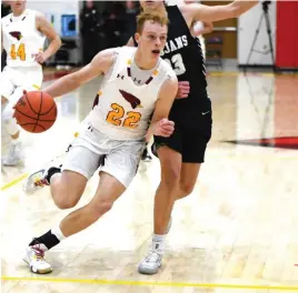  ?? Staff Photo/Jason Alig ?? Noah Topp of Botkins puts some pressure on Hayden Zeller of New Bremen as he drives to the hoop.*