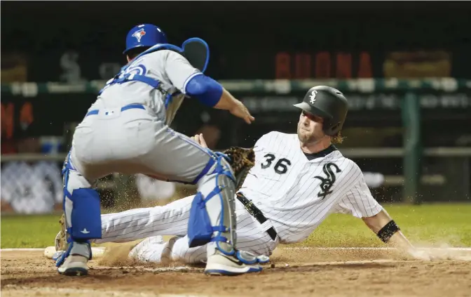  ?? AFP ?? CHICAGO: Kevan Smith #36 of the Chicago White Sox is tagged out at home by Russell Martin #55 of the Toronto Blue Jays in the eighth inning at Guaranteed Rate Field on Tuesday in Chicago, Illinois.—
