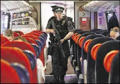  ?? YUI MOK / AP ?? Armed British Transport Police officers patrol a train at London’s Euston Station on Thursday. Investigat­ors say Monday’s suicide bombing in Manchester was retaliatio­n for the death of a Muslim man there last year.