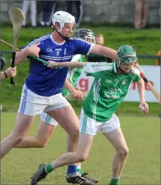  ??  ?? Evan O’Dwyer (Naomh Eanna) feels the heat from Shane Byrne.