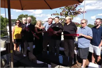  ?? BOB KEELER - MEDIANEWS GROUP ?? Surrounded by Perkasie officials, Janeen and Joe Wade, with Chef Jason Smith, cut the ribbon Aug. 5 for the new rooftop bar at The Ram.