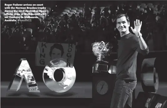  ?? Photo: VCG ?? Roger Federer arrives on court with the Norman Brookes trophy during the 2018 Australian Open official draw at Melbourne Park on Thursday in Melbourne, Australia.