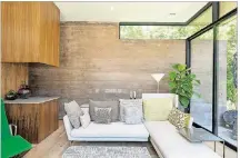 ??  ?? Wood mixes with interior fabrics to soften a concrete and glass home.