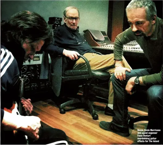  ??  ?? Rocco, Ennio Morricone and sound engeneer Fabio Venturi overdubbin­g guitar effects for The Island