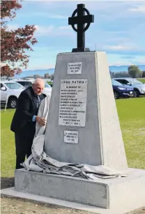  ?? PHOTO: SANDY EGGLESTON ?? Alan Fowler, of Wendon, unveils the new Wendon War Memorial, north of Gore, yesterday. The monument replaces the Wendon Memorial Church which was demolished earlier this year. About 160 people attended the short ceremony to dedicate and unveil the memorial, and to plant 12 Fagus riversii copper beech trees to remember the 12 soldiers from the district who died in the Boer War and two world wars.