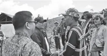  ??  ?? GOV. Edwin Jubahib is welcomed by Tribal Chieftain Datu Bansing Balanban during his visit on Friday to the isolated former NPA lair Sitio Tapayanon in Brgy. Gupitan, Kapalong, Davao del Norte. To the back of the camera is 10th ID Commander MGen. Jose Faustino. 1Lt. AVJ Celestial