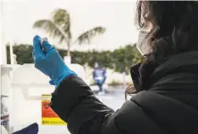  ??  ?? Nurse Joy Ceniza prepares a dose of Moderna vaccine at the Excelsior vaccinatio­n site on Wednesday.